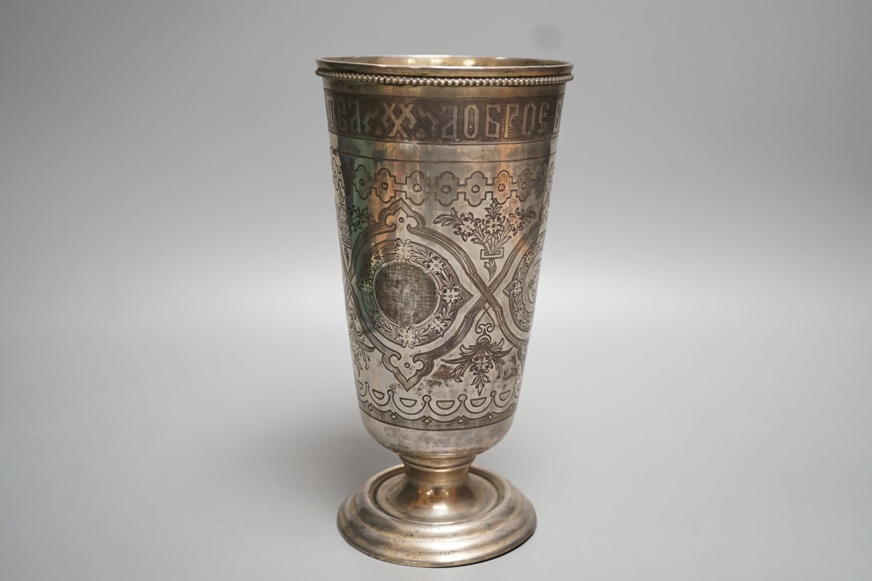 A continental white metal and niello vase, with inscription and decorated with foliate scrolls, 22.6cm, gross 15oz.